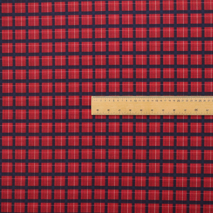 Bold red and navy plaid fabric featuring a structured checked pattern with prominent dark navy grids, vibrant red blocks, and subtle white pin lines.
