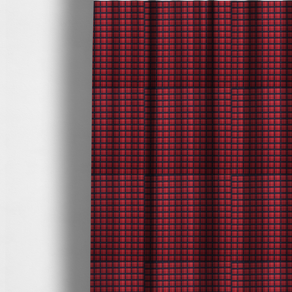 The fabric used to create these made-to-measure curtains is a bold red and navy plaid fabric featuring a structured checked pattern with prominent dark navy grids, vibrant red blocks, and subtle white pin lines.