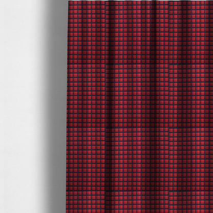 The fabric used to create these made-to-measure curtains is a bold red and navy plaid fabric featuring a structured checked pattern with prominent dark navy grids, vibrant red blocks, and subtle white pin lines.