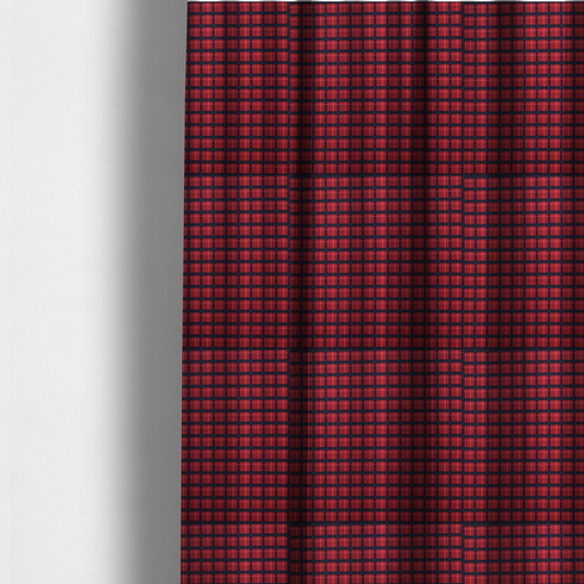 The fabric used to create these made-to-measure curtains is a bold red and navy plaid fabric featuring a structured checked pattern with prominent dark navy grids, vibrant red blocks, and subtle white pin lines.