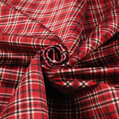 Classic red and black tartan plaid fabric featuring a traditional checked pattern with intersecting lines in rich red, dark black, and subtle white highlights.