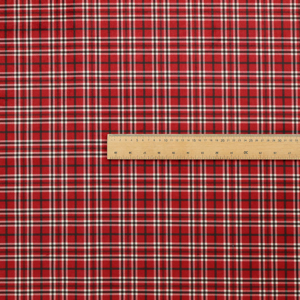 Classic red and black tartan plaid fabric featuring a traditional checked pattern with intersecting lines in rich red, dark black, and subtle white highlights.