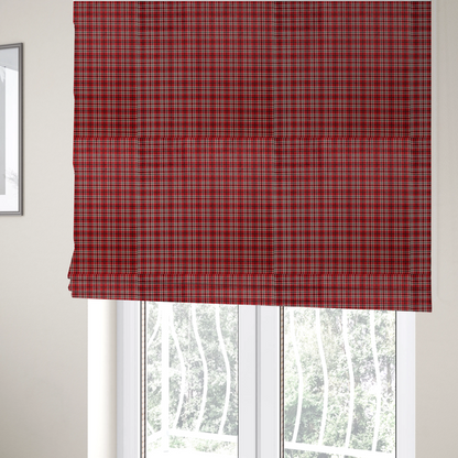 The fabric used to create these Roman blinds is a classic red and black tartan plaid fabric featuring a traditional checked pattern with intersecting lines in rich red, dark black, and subtle white highlights.