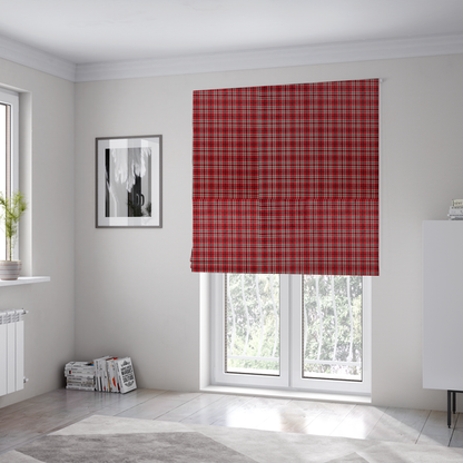 The fabric used to create these Roman blinds is a classic red and black tartan plaid fabric featuring a traditional checked pattern with intersecting lines in rich red, dark black, and subtle white highlights.