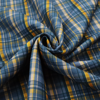 Blue and gold plaid fabric featuring a structured checked pattern with intersecting lines in muted slate blue, deep navy, vibrant gold, and crisp white pin lines.