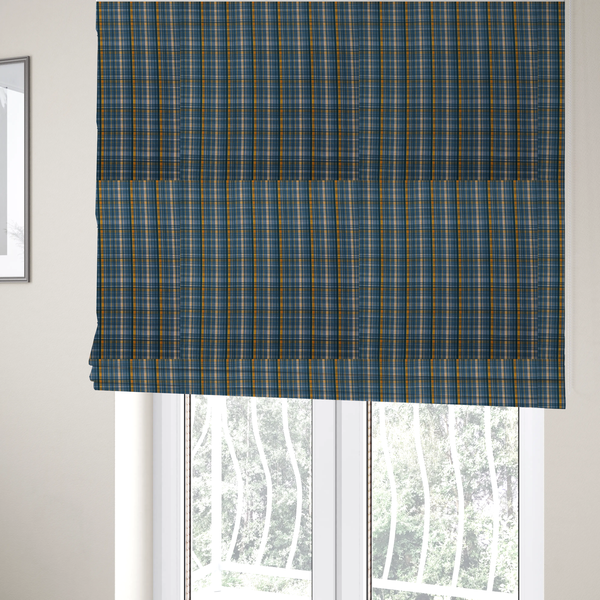 The fabric used to create these Roman blinds is a blue and gold plaid fabric featuring a structured checked pattern with intersecting lines in muted slate blue, deep navy, vibrant gold, and crisp white pin lines.