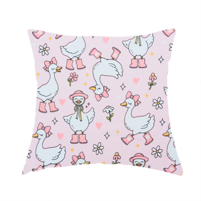 The fabric used to create this handmade cushion is a cute, whimsical cartoon print featuring white geese wearing pink rain boots and matching pink hats or bows, interspersed with small flowers, hearts, and sparkles.