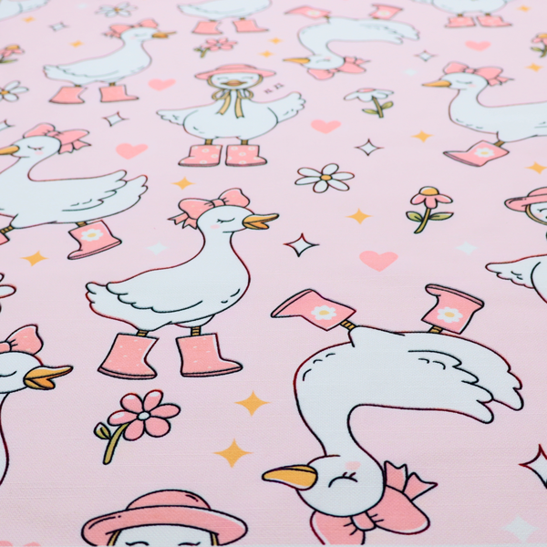A cute, whimsical cartoon print featuring white geese wearing pink rain boots and matching pink hats or bows, interspersed with small flowers, hearts, and sparkles.