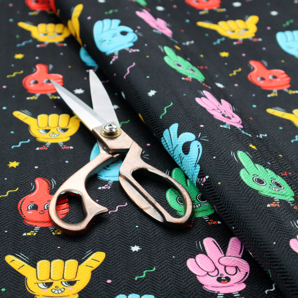 A quirky, fun cartoon print featuring anthropomorphic hands with cute faces making various gestures (like thumbs up, peace signs, and rock hand signs), scattered among tiny stars and squiggly lines.