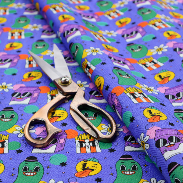 A vibrant, retro-cartoon all-over print featuring quirky, smiling food and character motifs against a blue-purple background.