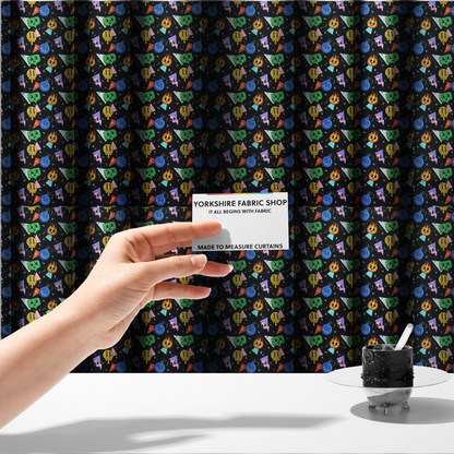 The fabric used to create these made-to-measure curtains is a retro, whimsical all-over print featuring an array of quirky, smiling cartoon characters and geometric shapes against a dark background.