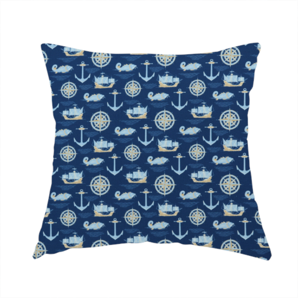 The fabric used to create this handmade cushion is a nautical-themed fabric pattern featuring alternating rows of light blue and gold sailing ships, compass roses, anchors, and fish against a dark blue background.