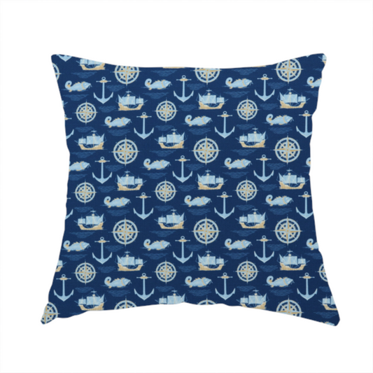 The fabric used to create this handmade cushion is a nautical-themed fabric pattern featuring alternating rows of light blue and gold sailing ships, compass roses, anchors, and fish against a dark blue background.