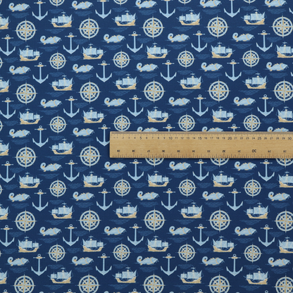 A nautical-themed fabric pattern featuring alternating rows of light blue and gold sailing ships, compass roses, anchors, and fish against a dark blue background.