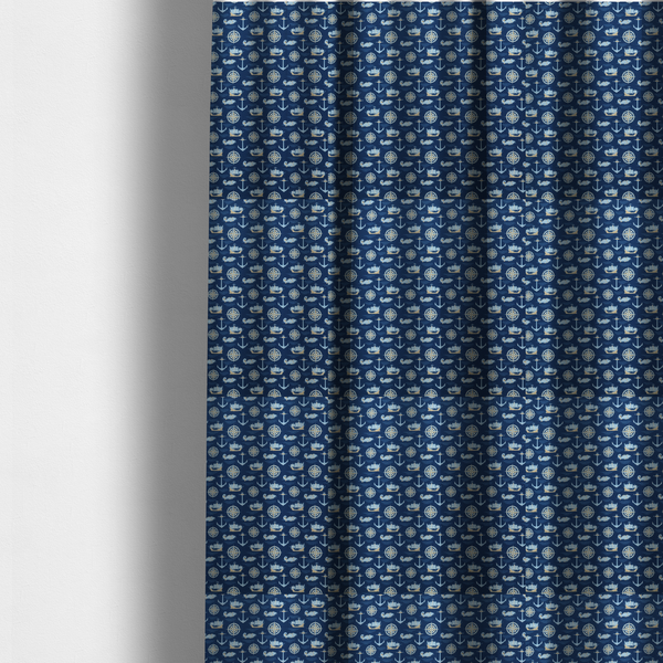 The fabric used to create these made-to-measure curtains is a nautical-themed fabric pattern featuring alternating rows of light blue and gold sailing ships, compass roses, anchors, and fish against a dark blue background.