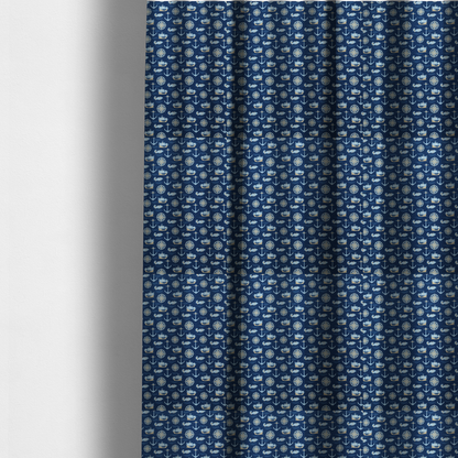 The fabric used to create these made-to-measure curtains is a nautical-themed fabric pattern featuring alternating rows of light blue and gold sailing ships, compass roses, anchors, and fish against a dark blue background.