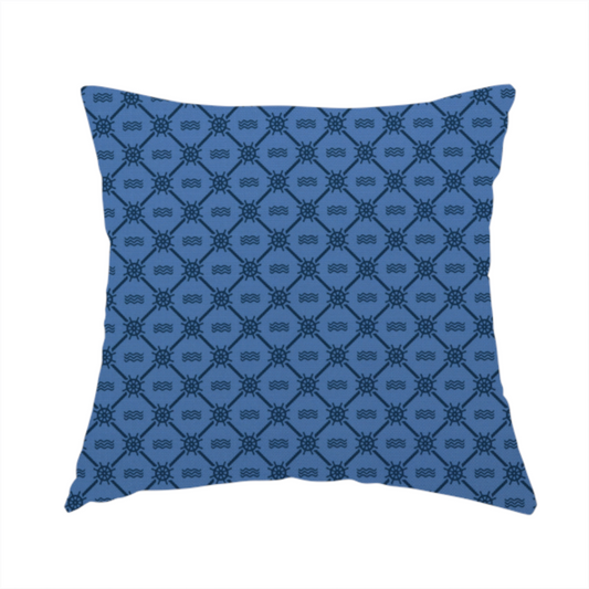 The fabric used to create this handmade cushion is a nautical-themed fabric pattern featuring a repeating navy blue geometric grid of ship's wheels and small wavy lines against a medium blue background.
