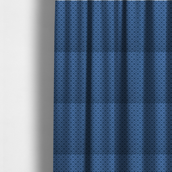 The fabric used to create these made-to-measure curtains is a nautical-themed fabric pattern featuring a repeating navy blue geometric grid of ship's wheels and small wavy lines against a medium blue background.