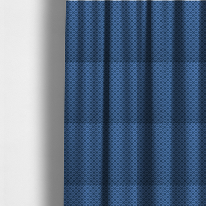 The fabric used to create these made-to-measure curtains is a nautical-themed fabric pattern featuring a repeating navy blue geometric grid of ship's wheels and small wavy lines against a medium blue background.