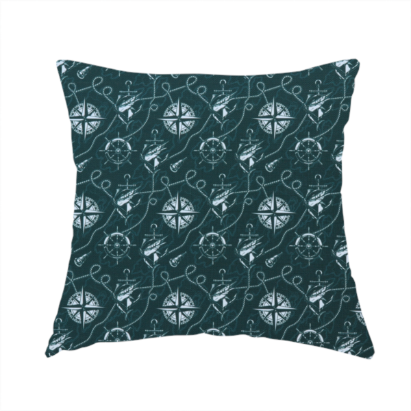 The fabric used to create this handmade cushion is a nautical-themed fabric pattern featuring light blue compass roses, ships, anchors, and intertwined ropes against a dark teal or green background.