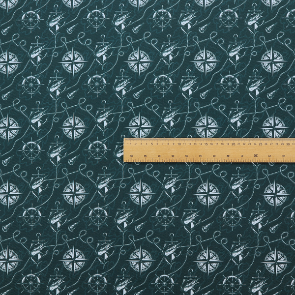 A nautical-themed fabric pattern featuring light blue compass roses, ships, anchors, and intertwined ropes against a dark teal or green background.
