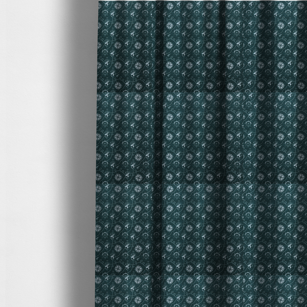 The fabric used to create these made-to-measure curtains is a nautical-themed fabric pattern featuring light blue compass roses, ships, anchors, and intertwined ropes against a dark teal or green background.