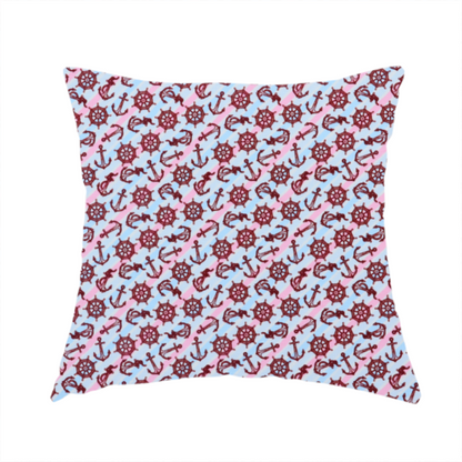 The fabric used to create this handmade cushion is a nautical-themed fabric pattern featuring diagonal stripes in light blue and pink, scattered with dark red ship's wheels and anchors.