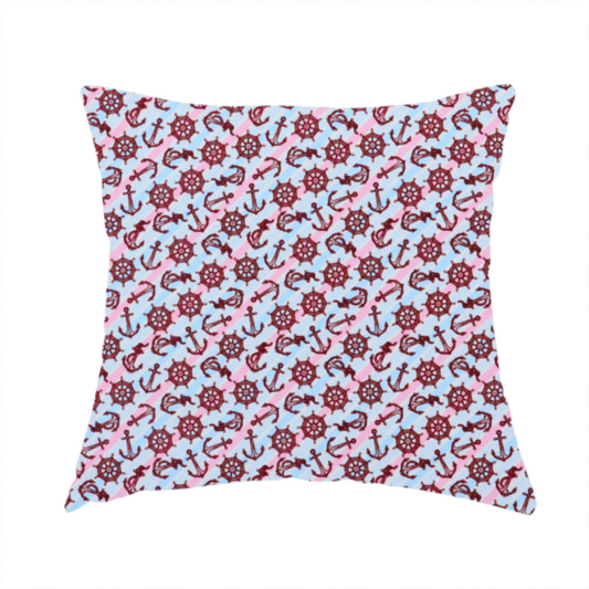 The fabric used to create this handmade cushion is a nautical-themed fabric pattern featuring diagonal stripes in light blue and pink, scattered with dark red ship's wheels and anchors.