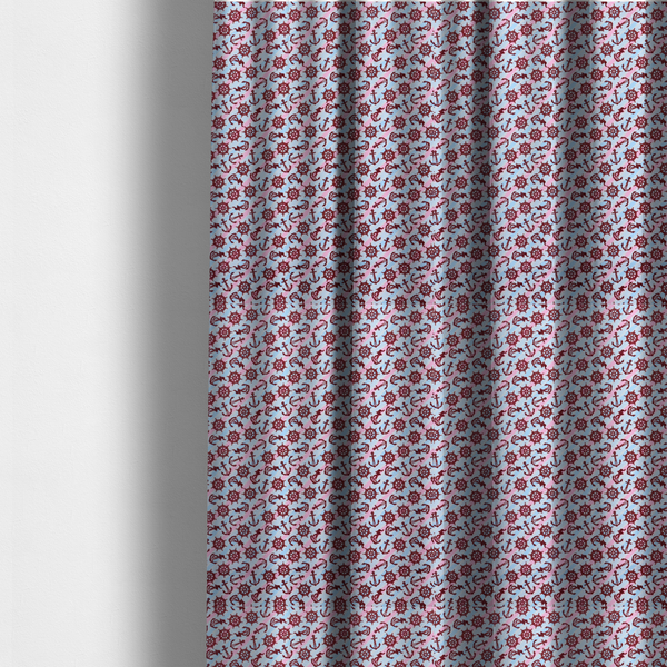 The fabric used to create these made-to-measure curtains is a nautical-themed fabric pattern featuring diagonal stripes in light blue and pink, scattered with dark red ship's wheels and anchors.
