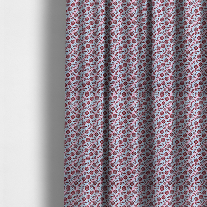 The fabric used to create these made-to-measure curtains is a nautical-themed fabric pattern featuring diagonal stripes in light blue and pink, scattered with dark red ship's wheels and anchors.