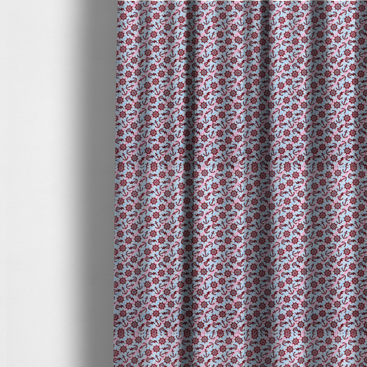 The fabric used to create these made-to-measure curtains is a nautical-themed fabric pattern featuring diagonal stripes in light blue and pink, scattered with dark red ship's wheels and anchors.