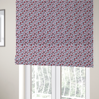 The fabric used to create these Roman blinds is a nautical-themed fabric pattern featuring diagonal stripes in light blue and pink, scattered with dark red ship's wheels and anchors.