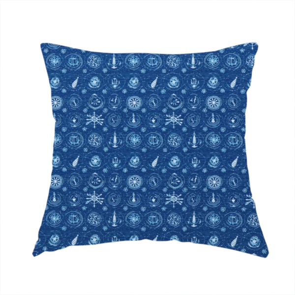 The fabric used to create this handmade cushion is a nautical-themed fabric pattern featuring an all-over small-scale print of white ship's wheels, anchors, compass roses, and nautical motifs against a textured dark blue background.