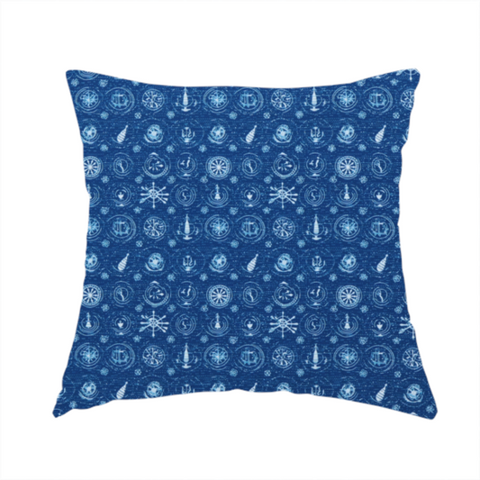 The fabric used to create this handmade cushion is a nautical-themed fabric pattern featuring an all-over small-scale print of white ship's wheels, anchors, compass roses, and nautical motifs against a textured dark blue background.