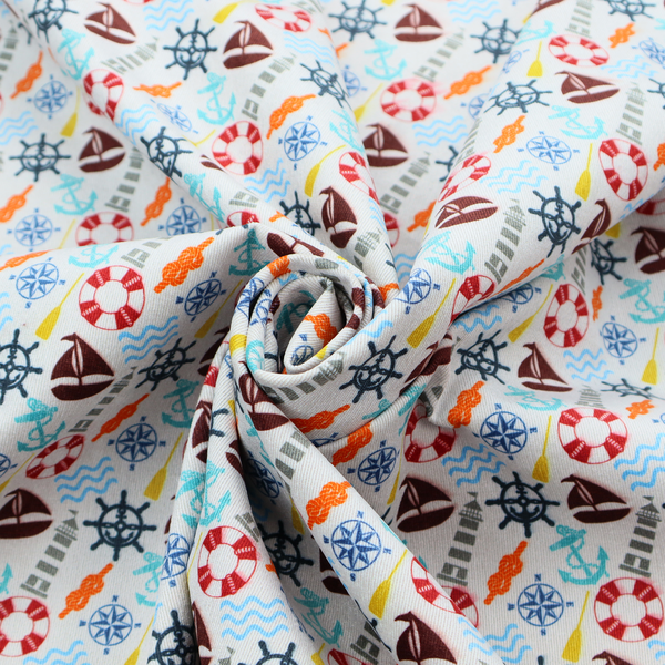 A colourful nautical-themed fabric pattern featuring a repeating mix of lighthouses, sailboats, life rings, ship's wheels, anchors, and waves against a white background.