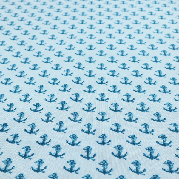A nautical-themed fabric pattern featuring a repeating print of dark blue anchors against a light blue background.