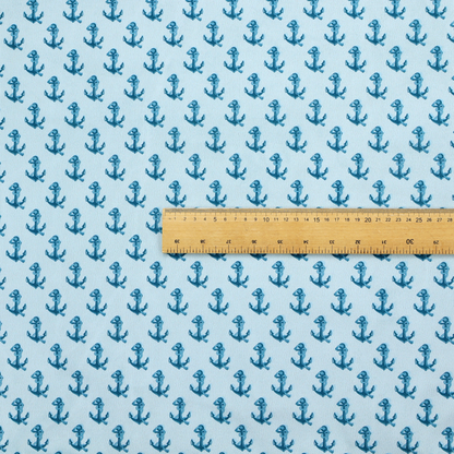 A nautical-themed fabric pattern featuring a repeating print of dark blue anchors against a light blue background.