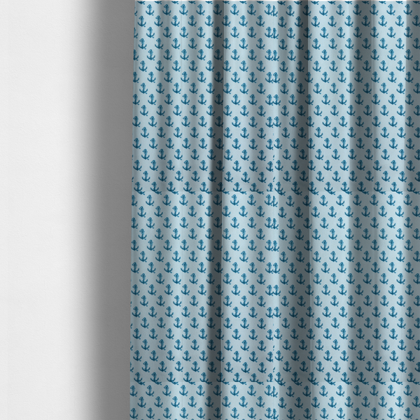 The fabric used to create these made-to-measure curtains is a nautical-themed fabric pattern featuring a repeating print of dark blue anchors against a light blue background.