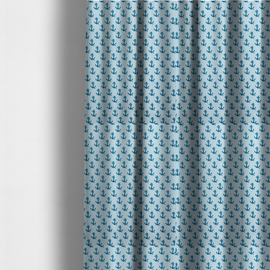 The fabric used to create these made-to-measure curtains is a nautical-themed fabric pattern featuring a repeating print of dark blue anchors against a light blue background.