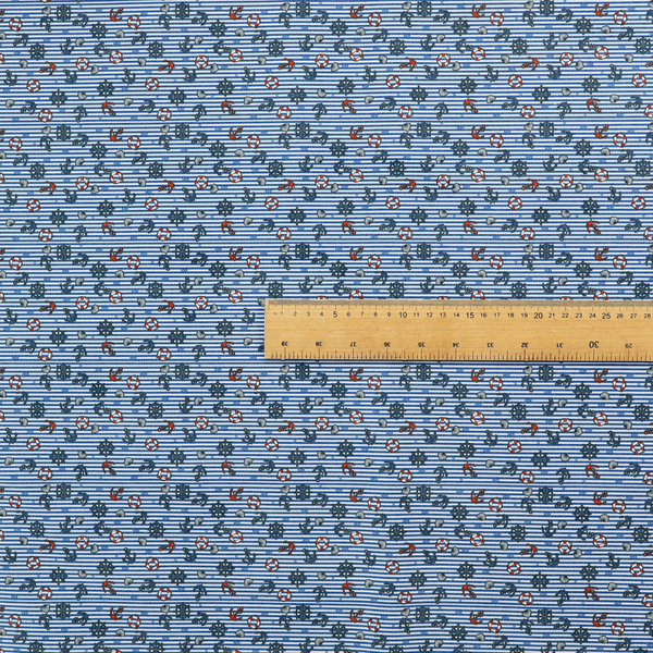 The pattern features a nautical theme filled with tiny ships' steering wheels, anchors, and lifebuoys scattered across the fabric.