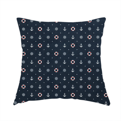 The fabric used to create this handmade cushion is a pattern features a nautical-themed design consisting of alternating rows and grids of white anchors, ship's steering wheels, and red-and-white lifebuoys, accented by small white polka dots.