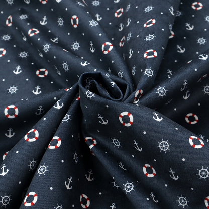 The pattern features a nautical-themed design consisting of alternating rows and grids of white anchors, ship's steering wheels, and red-and-white lifebuoys, accented by small white polka dots.
