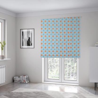 The fabric used to create these Roman blinds is a pattern features a nautical-themed design consisting of alternating rows of ship's steering wheels and small anchors.