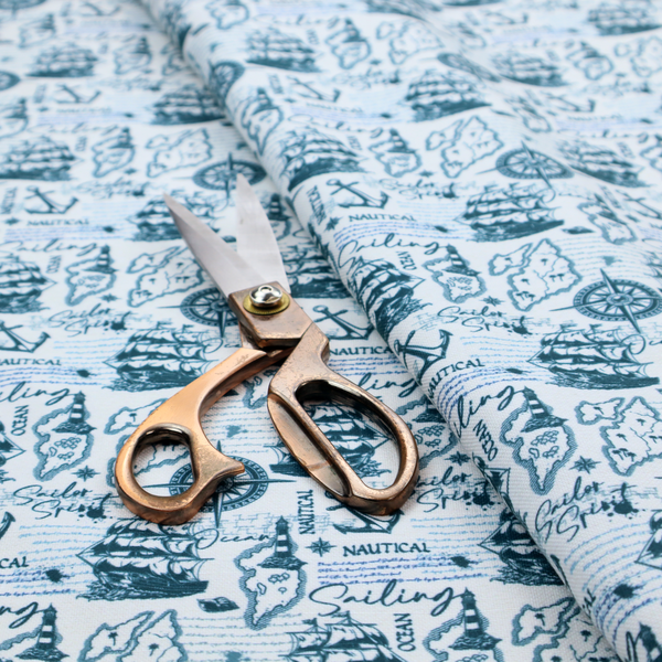 The pattern features a dense nautical collage consisting of sailing ships, maps or landmasses, compass roses, anchors, lighthouses, and cursive typography with words like "Sailing," "Ocean," "Nautical," and "Sailor Spirit."