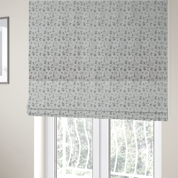 The fabric used to create these Roman blinds is a pattern features a nautical-themed collage containing lighthouses, sailing ships, anchors, compass roses, seashells, steering wheels, ship bells, and marlin fish.