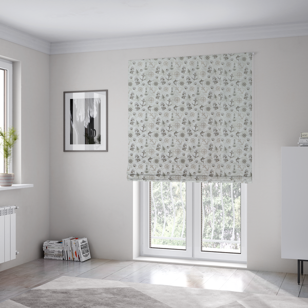 The fabric used to create these Roman blinds is a pattern features a nautical-themed collage containing lighthouses, sailing ships, anchors, compass roses, seashells, steering wheels, ship bells, and marlin fish.