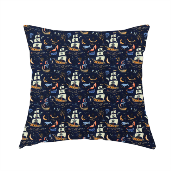 The fabric used to create this handmade cushion is a dark navy blue fabric patterned with a repeating pirate-themed design featuring multi-sailed galleon ships with skull-and-crossbones flags sailing on stylized waves, accompanied by smaller elements including blue whales, crescent moons, skulls, tropical palm trees, and anchors.