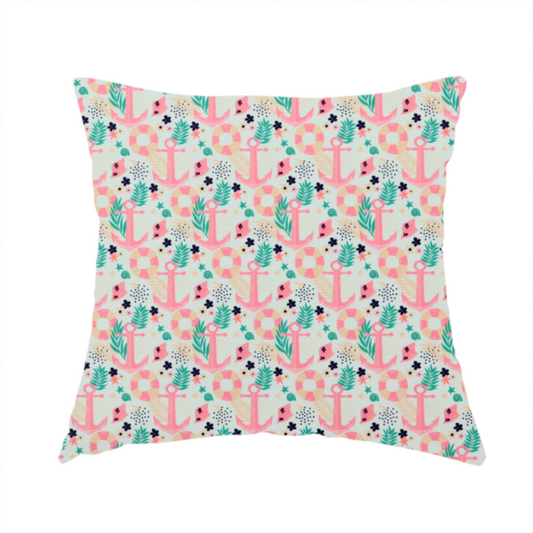 The fabric used to create this handmade cushion is a light mint green fabric with a repeating nautical pattern featuring pink anchors framed by teal palm fronds, interspersed with pink and white striped life rings, tiny dark blue flowers, and small coral shells.