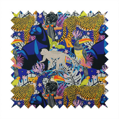 A vibrant jungle-themed fabric on a rich blue background featuring a repeating pattern of yellow leopards with black spots, blue panthers, toucans with bright orange and yellow beaks, light grey monkeys, small yellow-and-red birds, and lush tropical leaves and pink flowers.