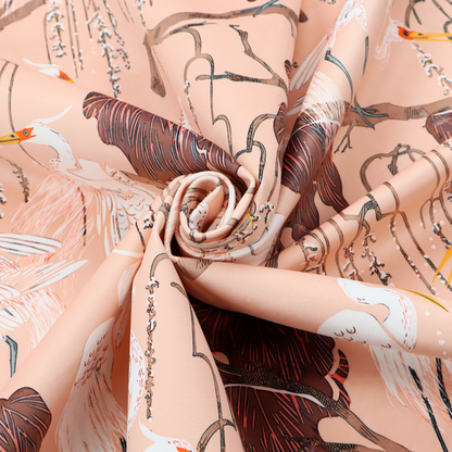 A peach-pink fabric with an illustrated botanical and avian pattern featuring white egrets perched on brown branches among dark red, stylized foliage and weeping floral tendrils.